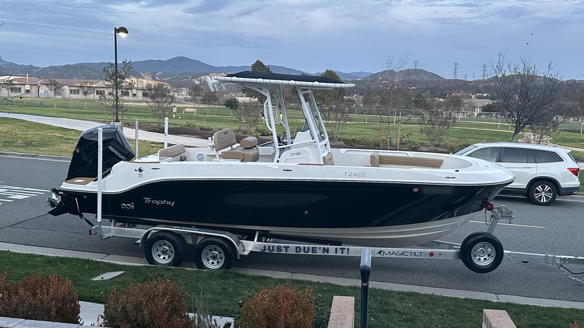 Custom boat name trailer decal reading JUST DUE'N IT! in bold block letters on an aluminum boat trailer frame
